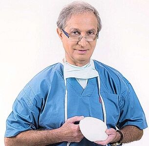 Doctor holding breast augmentation implant