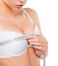 Girl measuring her breasts before breast augmentation